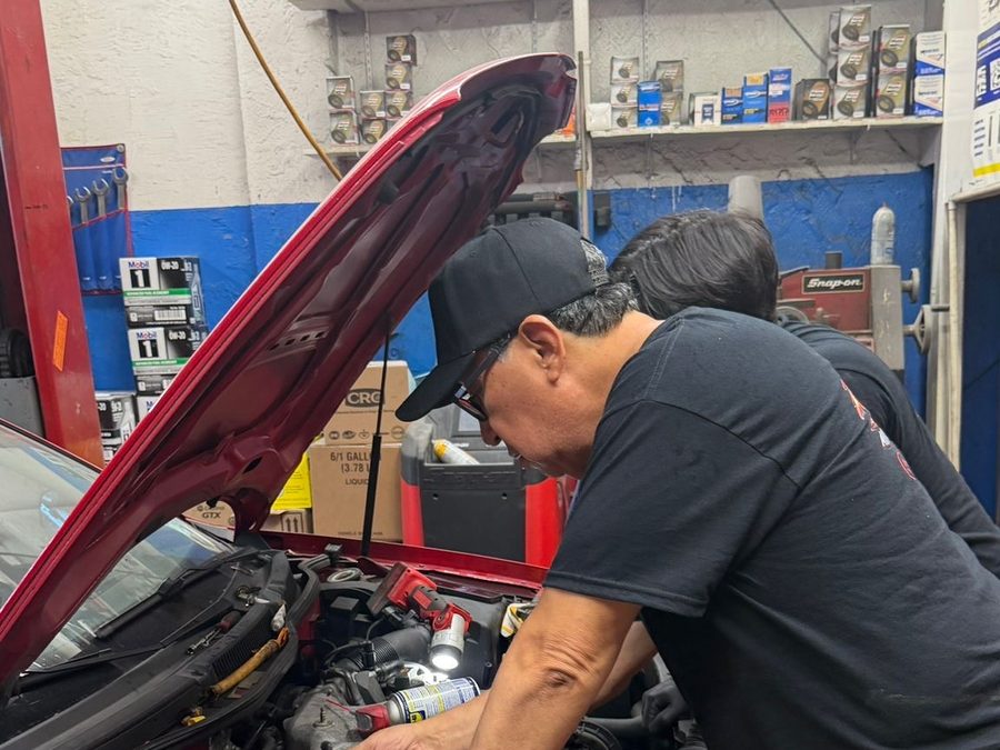 Technician performing engine diagnostics